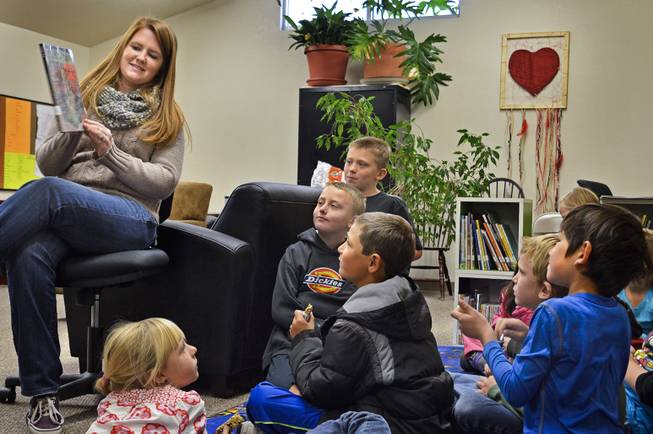 Michael-Ann Lazzarino shows children a book in the children's book nook in Virginia City in 2013. Lazzarino is the elementary programs director of Community Chest, a nonprofit group that opened the book nook last year in its community center. The Storey County Public Library closed in 2012.